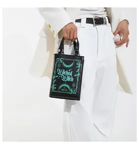 Detailed view of a unique book-shaped handbag featuring 'Wicked Witch' gothic print.