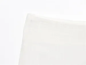 Close-up detail of premium white linen fabric texture and stitching.