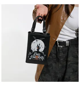 Close-up of quirky Halloween themed black box bag with castle and bat prints shown.