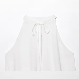 Elegant white linen halter neck top with neck-tie detail for a minimalist summer look.