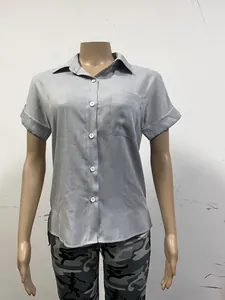 Detailed view of grey short-sleeved linen shirt with button front and chest pocket
