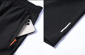 Vista dettagliata dei pantaloncini sportivi con striscia riflettente e tasca zip
