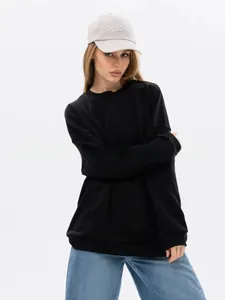Detailed look of black oversized crewneck sweatshirt with minimalist streetwear style