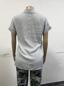 Macro view of the back of a grey short-sleeved linen blouse with textured fabric