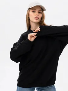 Macro detail showing the fabric and fit of a black minimalist crewneck sweatshirt