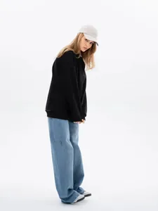 Female model posing in an oversized minimalist black round neck thick sweatshirt