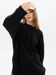 Detail view of a thick black oversized crewneck sweatshirt with comfortable loose fit