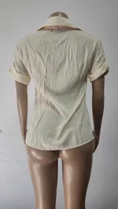 Detailed back view of a solid color beige linen short-sleeve casual loose shirt for women.
