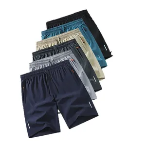 Pantaloncini sportivi traspiranti con strisce riflettenti e tasche con cerniera