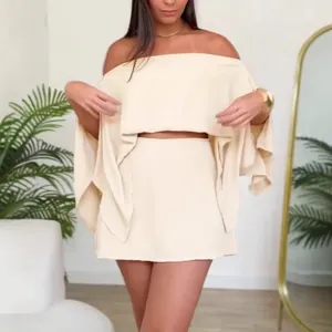 Detailed view of beige off-shoulder two-piece set featuring split sleeves and a mini skirt