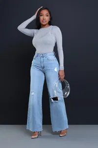 Fashionable high-waisted wide-leg jeans with ripped details for a casual look.