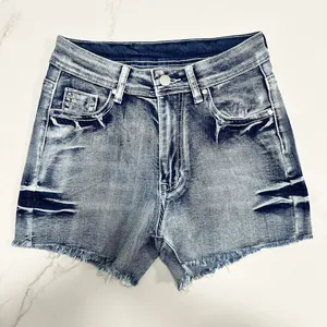 Detailed view of high-waisted vintage wash denim shorts featuring a stylish frayed raw hem