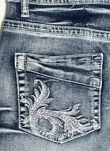 Detail shot of white embroidery on the back pocket of 2025 summer vintage denim shorts.