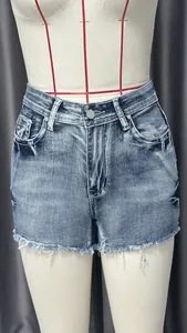 Vintage washed denim shorts detail featuring frayed raw hems and classic slim fit design
