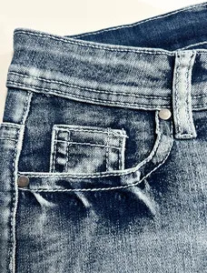 Close-up macro of retro denim shorts showing pocket details and premium stitch texture.