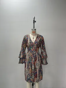 Close-up detail of a colorful paisley print summer dress featuring tiered bell sleeves