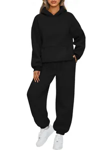 Full body view of a women's black two-piece tracksuit set with an oversized hoodie
