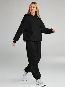 Close-up detail of women's black hooded sweatshirt and matching sweatpants loungewear set