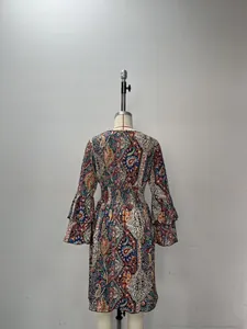Back view of bohemian paisley print dress with tiered bell sleeves and elastic waist