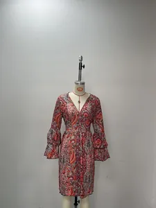 Close-up of vintage paisley print V-neck dress with layered bell sleeves on mannequin