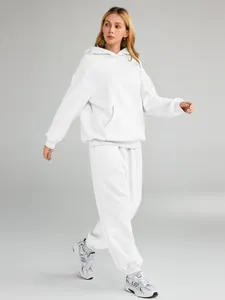 Full view of women's white oversized hoodie and jogger sweatpants set on model