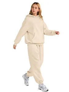 Detail of women's beige oversized hoodie and joggers tracksuit set.