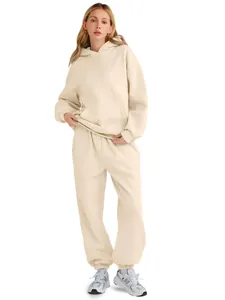 Women's beige oversized hoodie and matching sweatpants set shown on a studio model