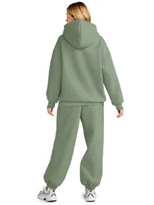 Back view detail of women's oversized sage green hooded sweatshirt and jogger set.