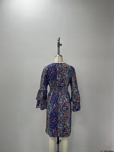 Back view of a bohemian paisley print summer dress with ruffled sleeves and elastic waist.