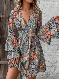 Close-up detail of a colorful paisley print summer dress featuring elegant flared sleeves