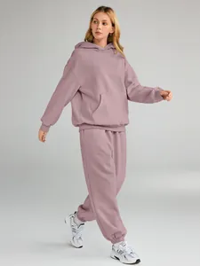 Full body view of a women's mauve oversized hooded tracksuit with matching joggers.