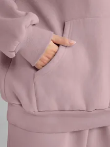 Detailed macro view of pink oversized hoodie pocket and ribbed cuffs for a cozy look