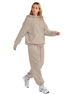Full-body shot of a beige oversized hooded sweatshirt and matching sweatpants set