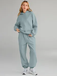 Full-length view of a women's light blue oversized hooded tracksuit and matching joggers.