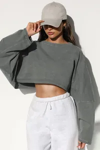 Detailed view of women's oversized crop sweatshirt in premium washed gray cotton fabric