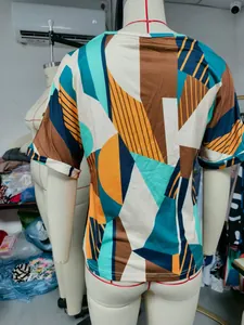 Back view of women's short sleeve T-shirt with vibrant geometric color block print.