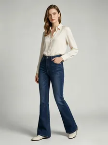 Close-up detail of high-waisted flare jeans with a dark blue wash and slim fit