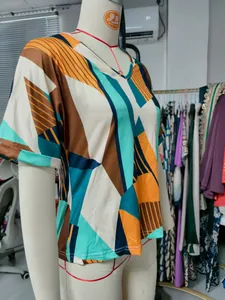 Detailed view of women's V-neck T-shirt with vibrant geometric color-block print