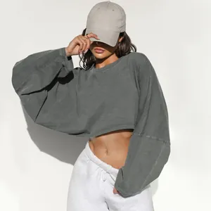 Close-up detail of a charcoal grey cropped crew neck sweatshirt with long sleeves