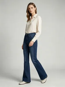 Side view showing the fit and silhouette of high waisted flared blue jeans for women