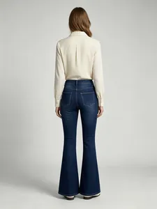 Detailed back view of stylish women's high-waisted dark blue flare denim jeans