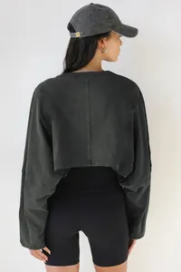 Back view of a washed grey cropped long-sleeve sweatshirt for women with crew neck