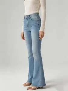 Side view detail showing the fit and flare cut of high-waisted light blue denim jeans