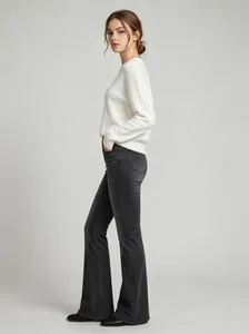 Side view of high-waisted black flared jeans for women with slim fit detail