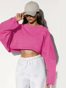 Detail shot of the pink cropped long sleeve sweatshirt featuring a round neck design