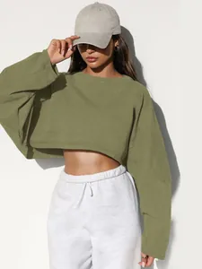 Close-up of olive green cropped crewneck sweatshirt with long sleeves on model