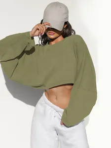 Detail showing cropped olive green long sleeve sweatshirt on model with white background