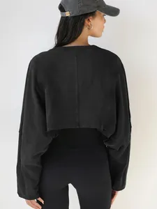 Back view of a black cropped long-sleeve sweatshirt with a relaxed drop-shoulder fit