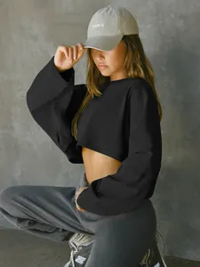Close-up of a stylish black cropped sweatshirt on a model for casual sports wear
