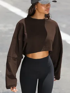 Detail view of a brown long-sleeved crop top sweatshirt for sports and casual wear